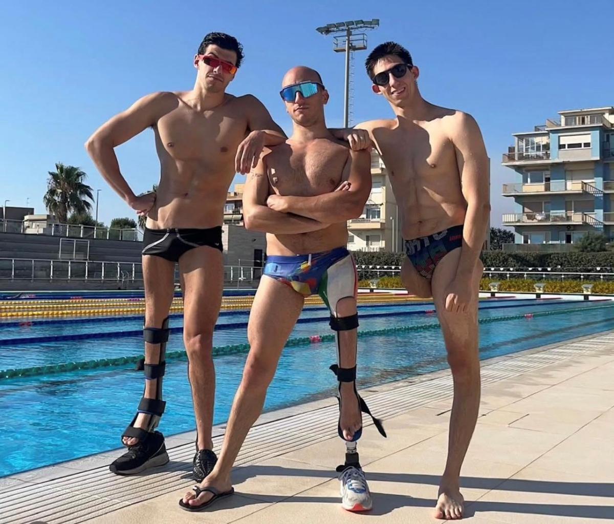Para swimmers strike for a pose.