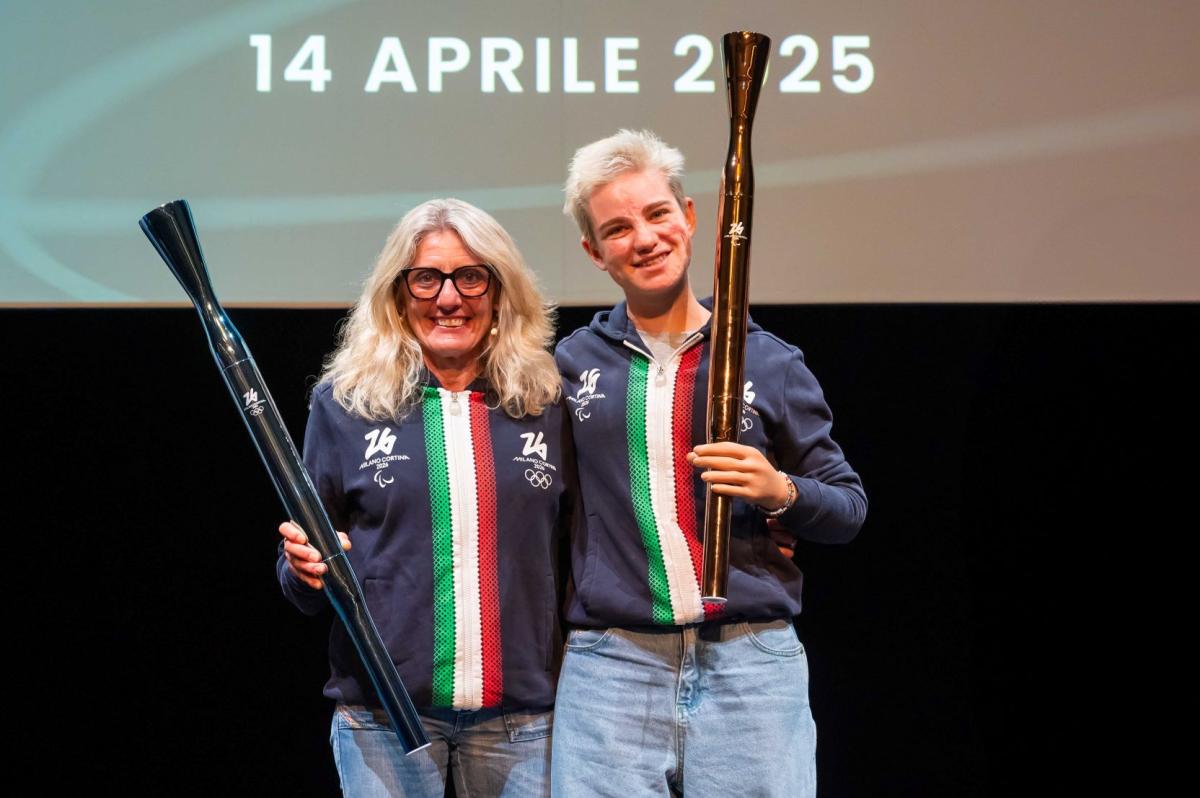 Bebe Vio and Stefania Belmond are holding the Milano Cortina 2026 torches during a presentation event.