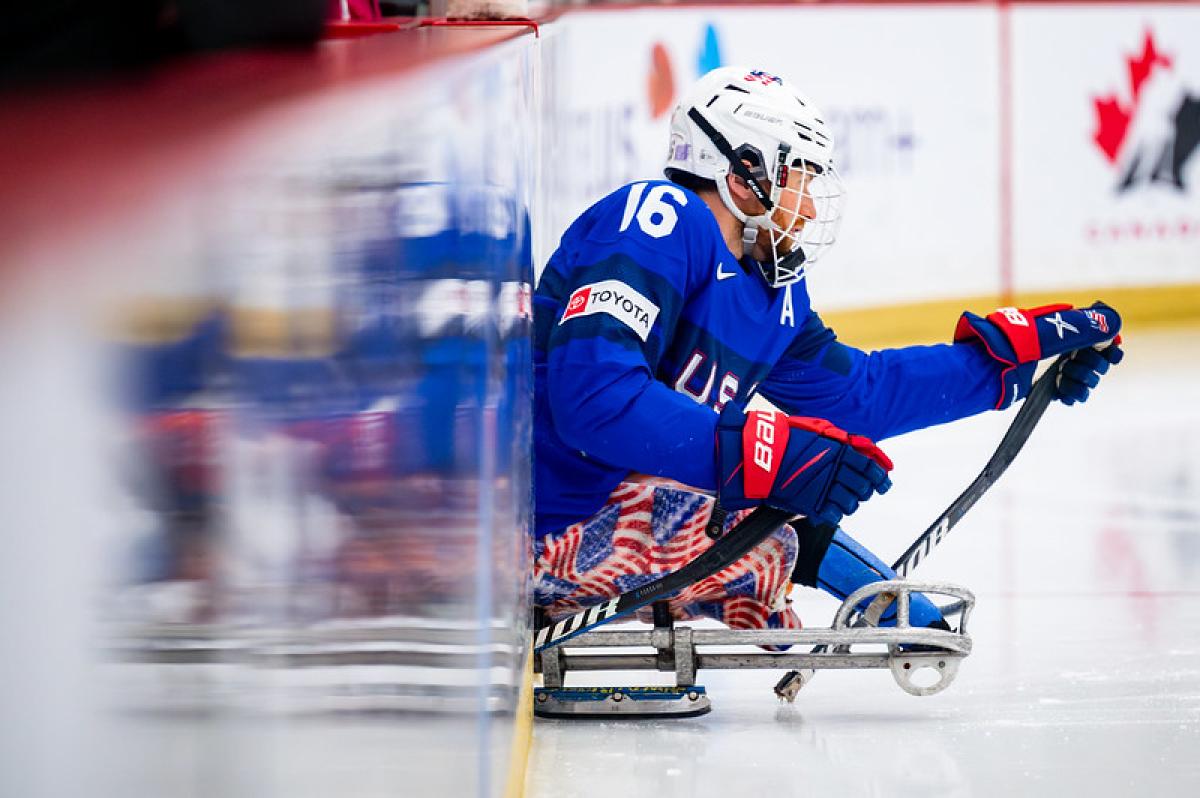 A male Para ice hockey player entering the rink