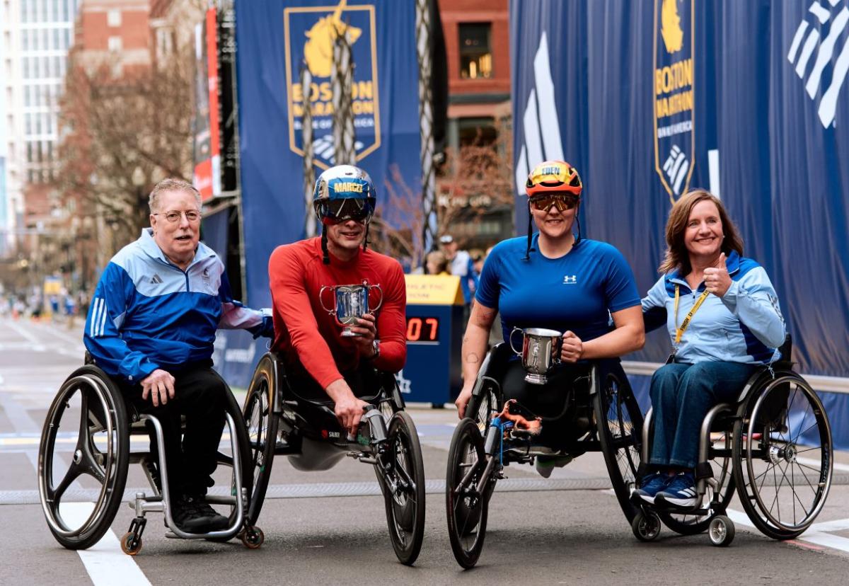 Two men and two women in wheelchairs on the streets of the 2025 Boston Marathon