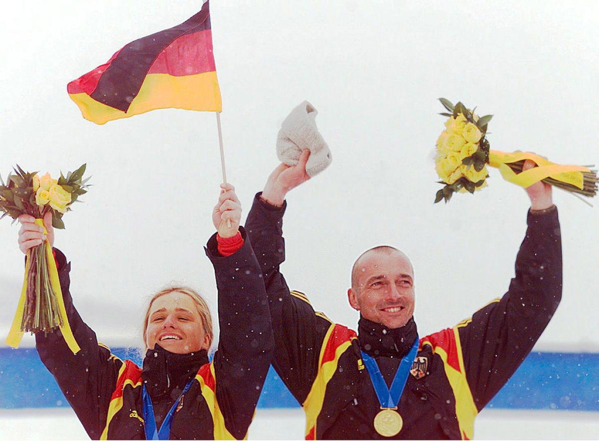 Verena Bentele celebrates on the podium with her guide at Salt Lake City 2002