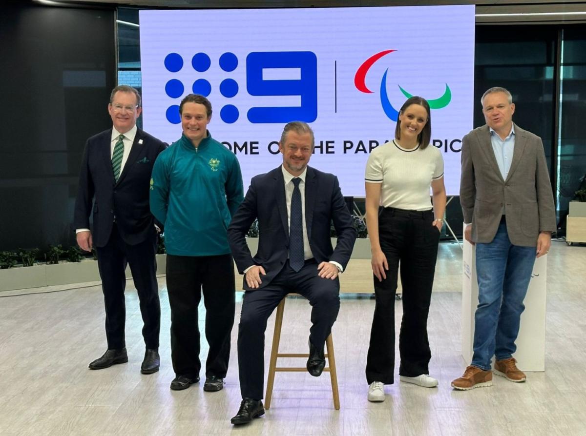 Five people pose for a photo
