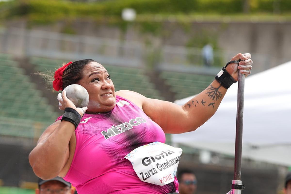 A female seated thrower competing in shot put