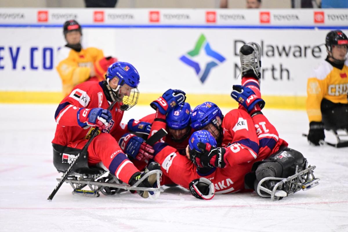A group of Czech Para ice hockey players celebrating on ice