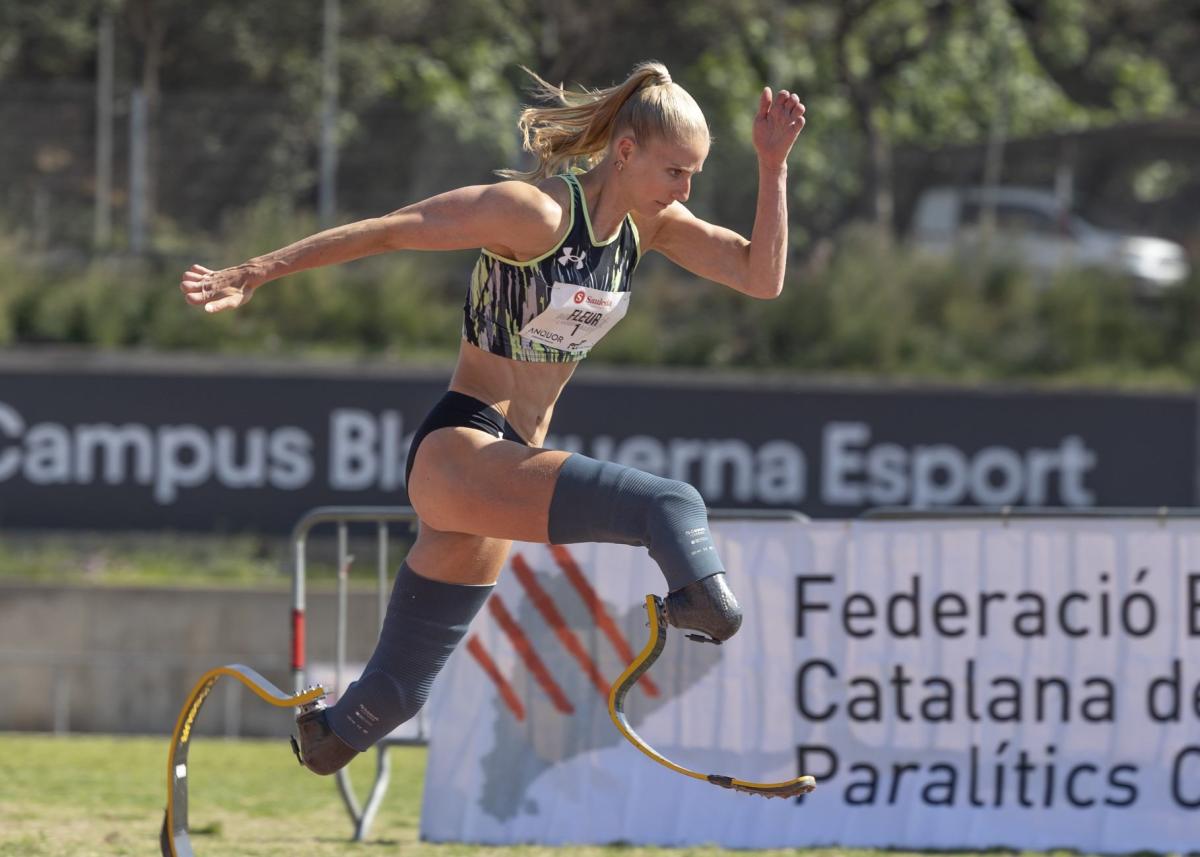 A woman in prosthetic legs running in a competition