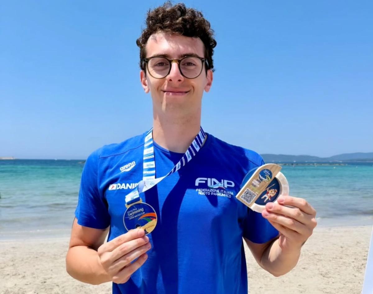 An athlete poses with his medal