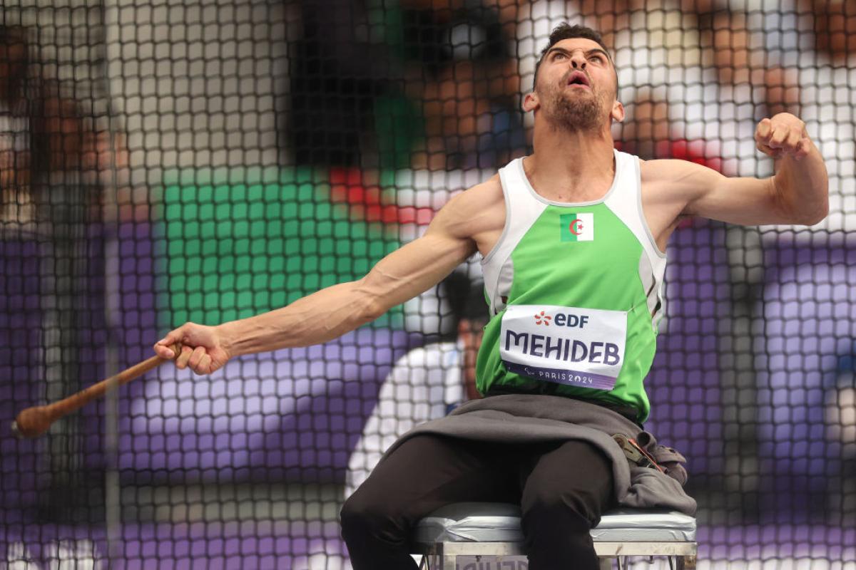 A male athlete competing in the club throw