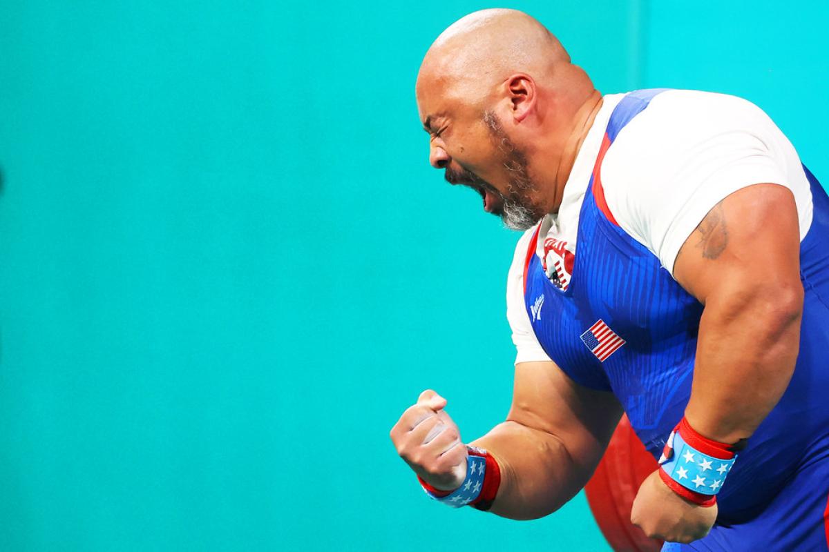 An athlete gestures after a lift