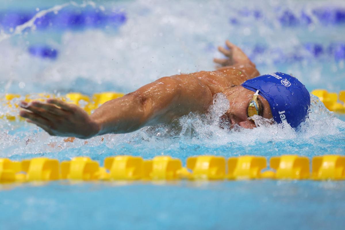 A male swimmer competing in butterfly