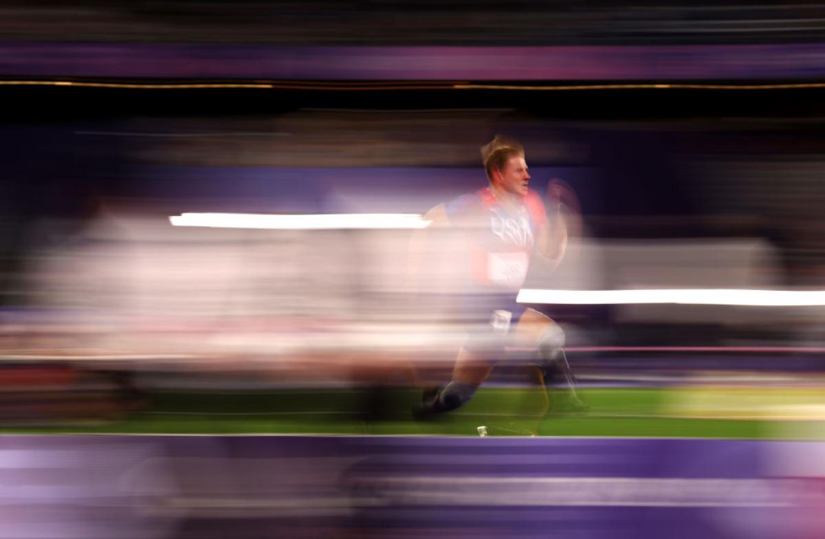 A man with prosthetic legs running in a track