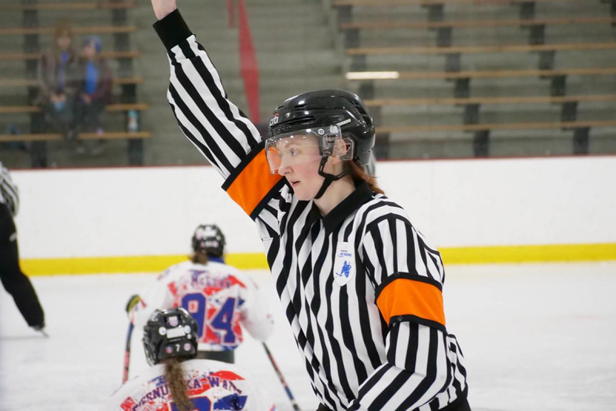 A female Para ice hockey official during a women's Para ice hockey game 