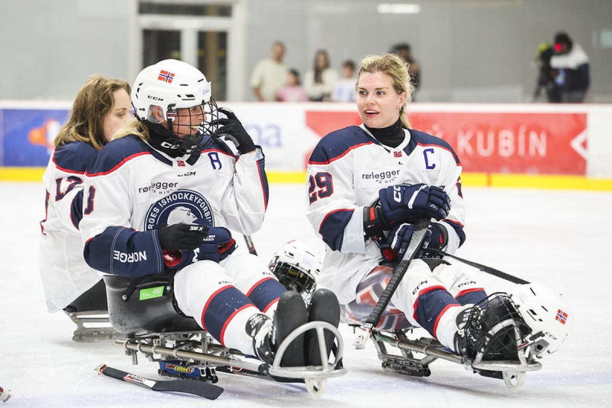 Three Norwegian Para ice hockey players on the ice after a game