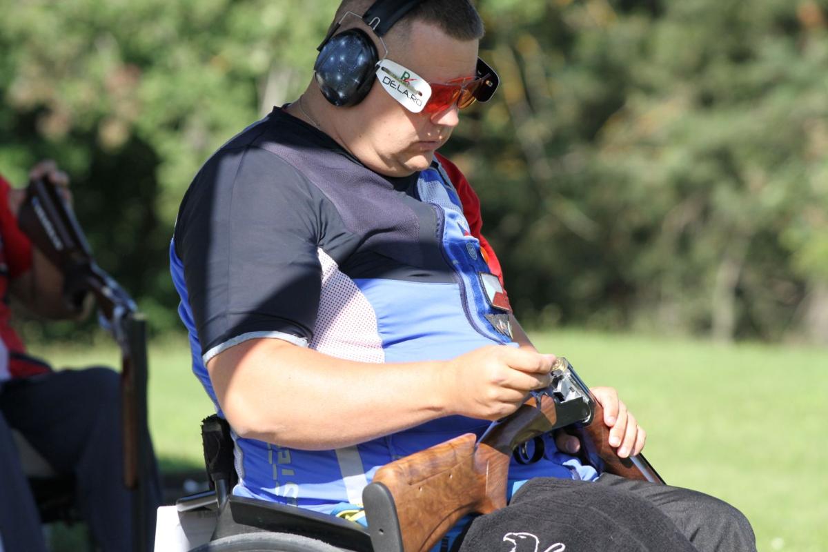 A shooter reloads his cartridge.