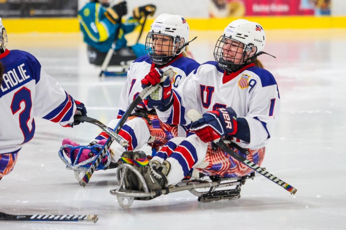 Three USA female Para ice hockey players celebrating