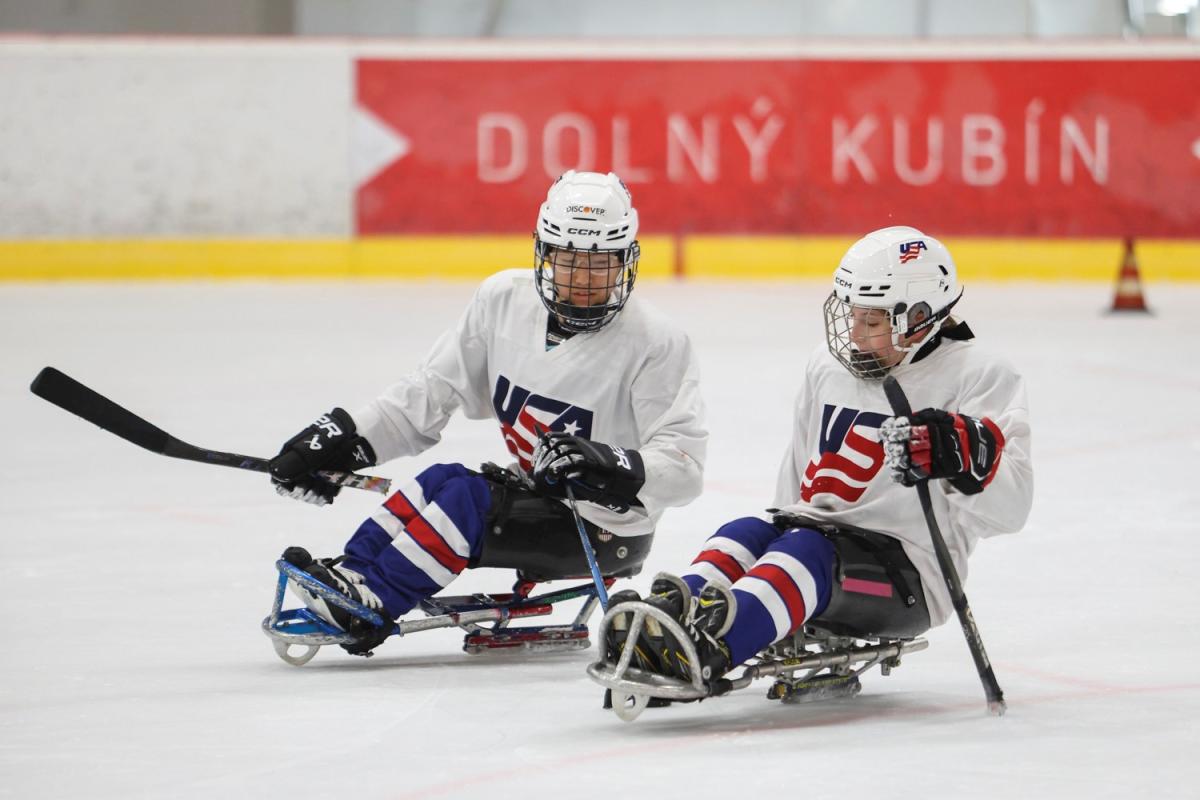 Two female USA Para ice hockey players during practice