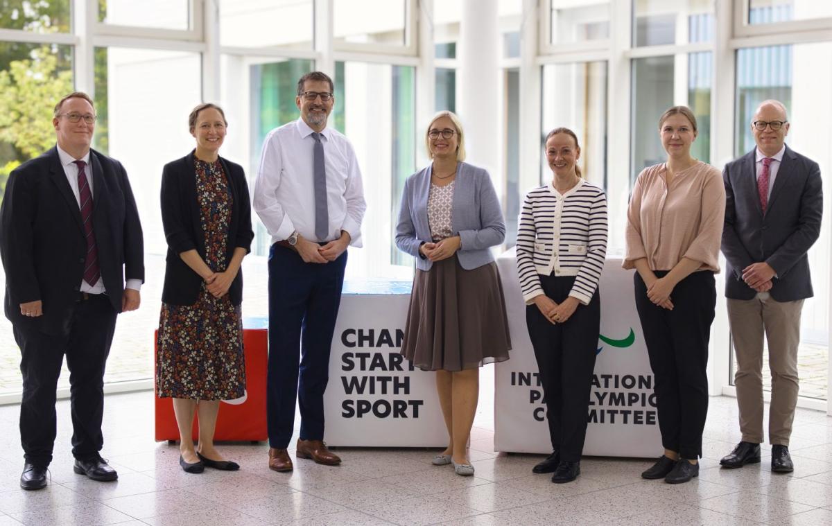 Seven people, including State Minister for Sport and Volunteering, pose for a photograph at the IPC Campus