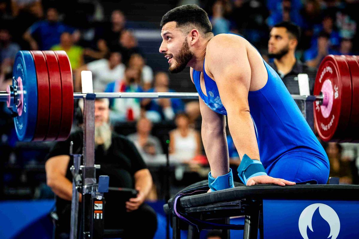 An athlete reacts after his round