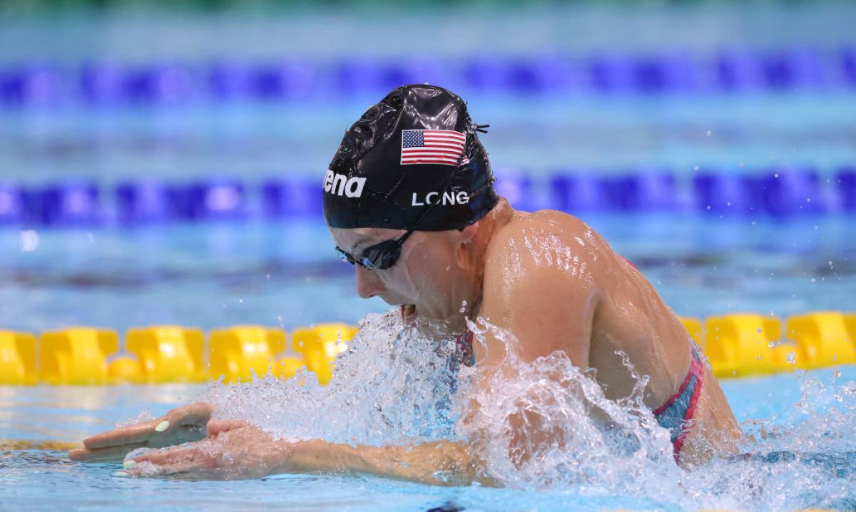 A female Para swimmer competing in breaststroke