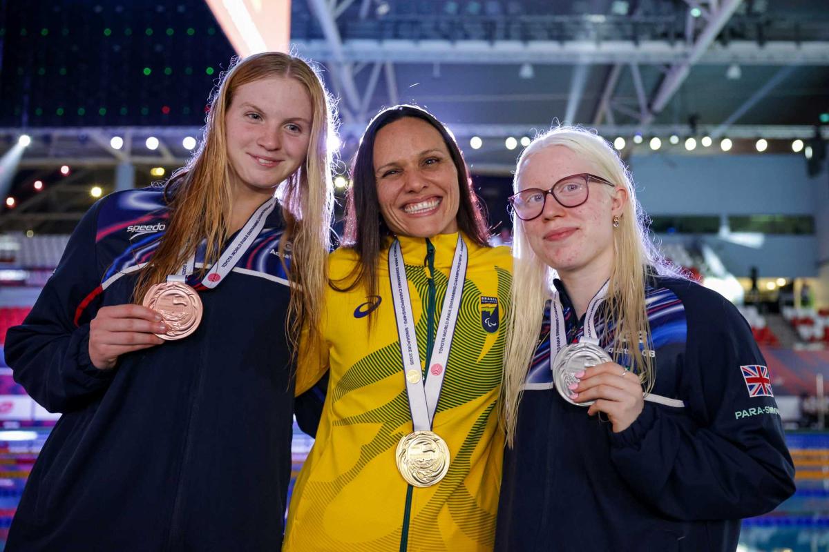 Three women showing their medals