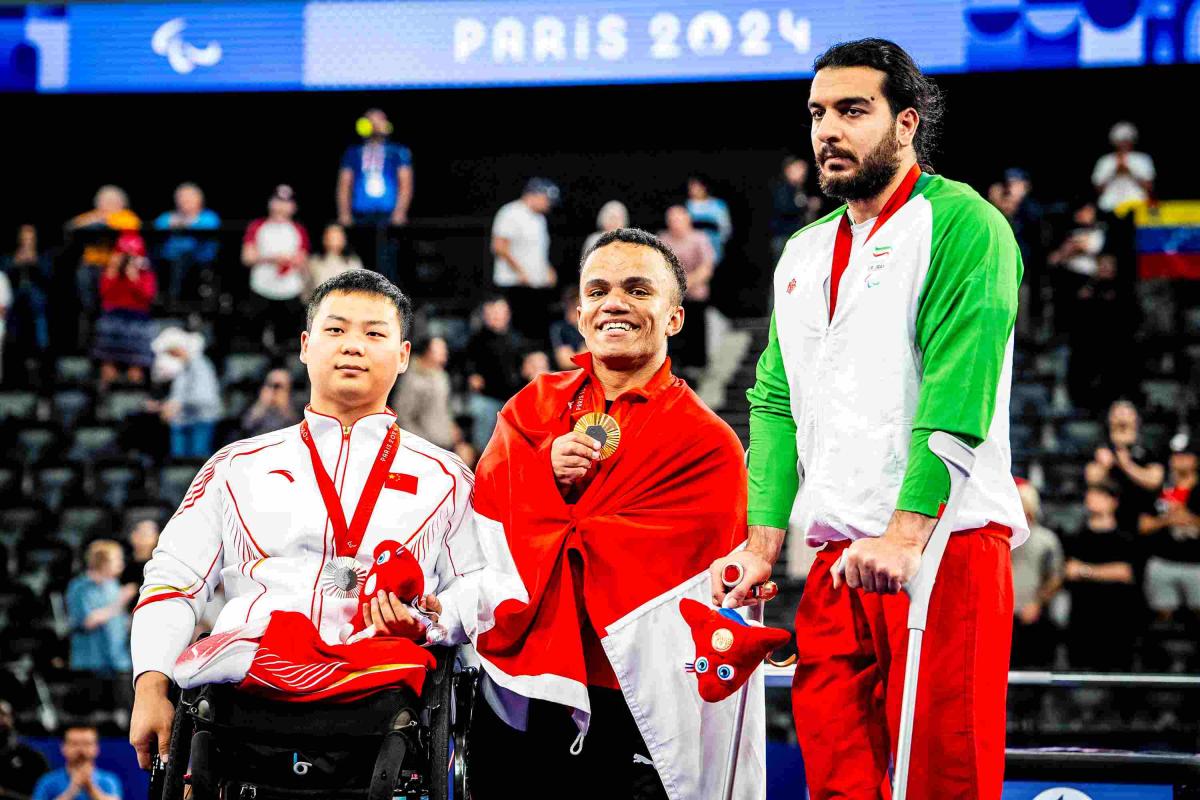 Athletes pose on the podium