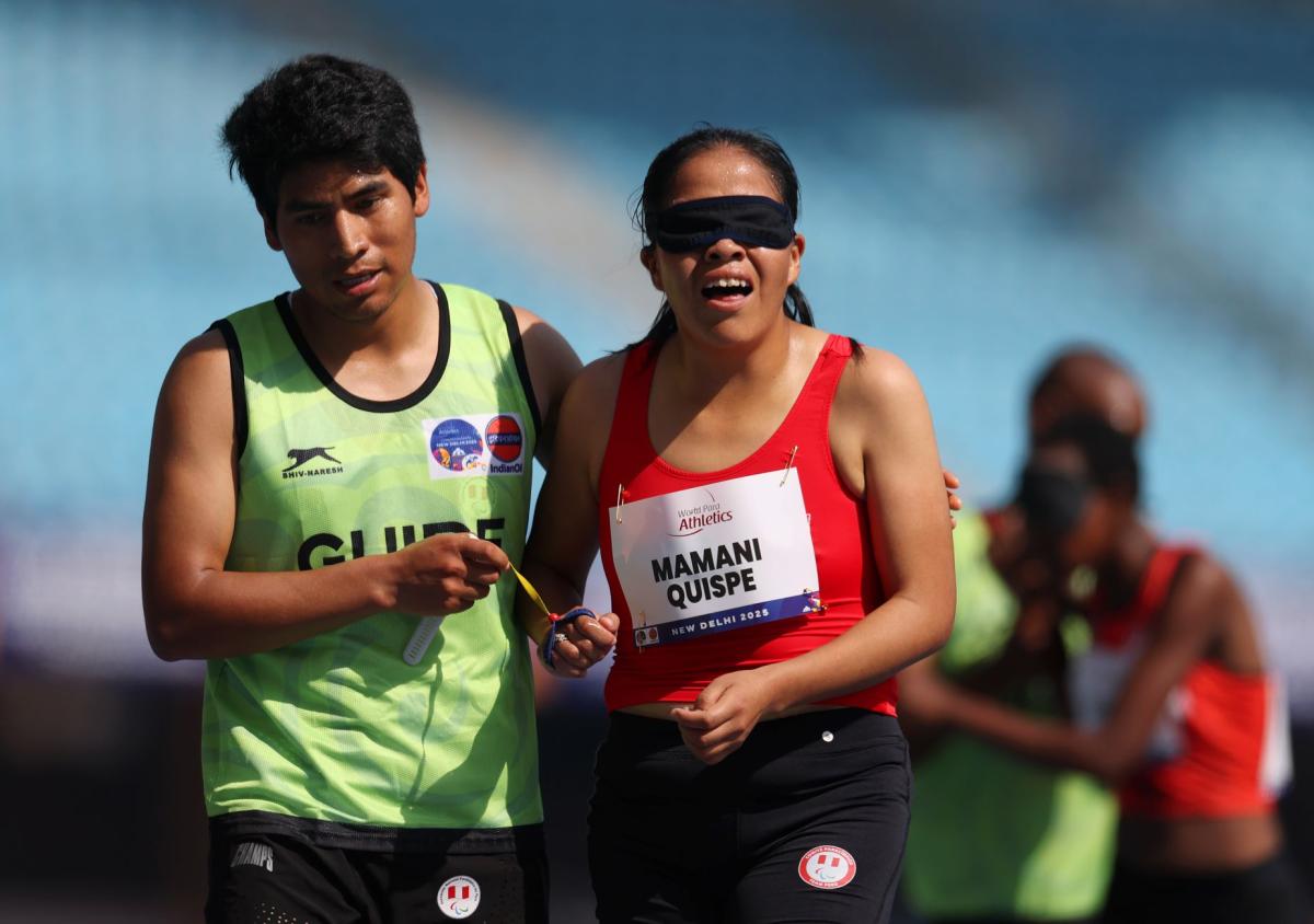 A vision impaired athlete reacts after her race