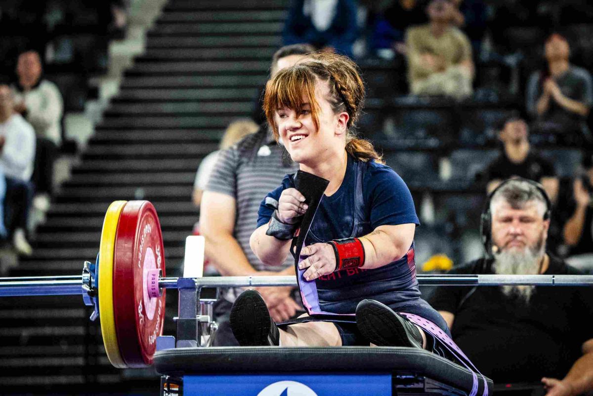 An athlete reacts in joy after a successful lift