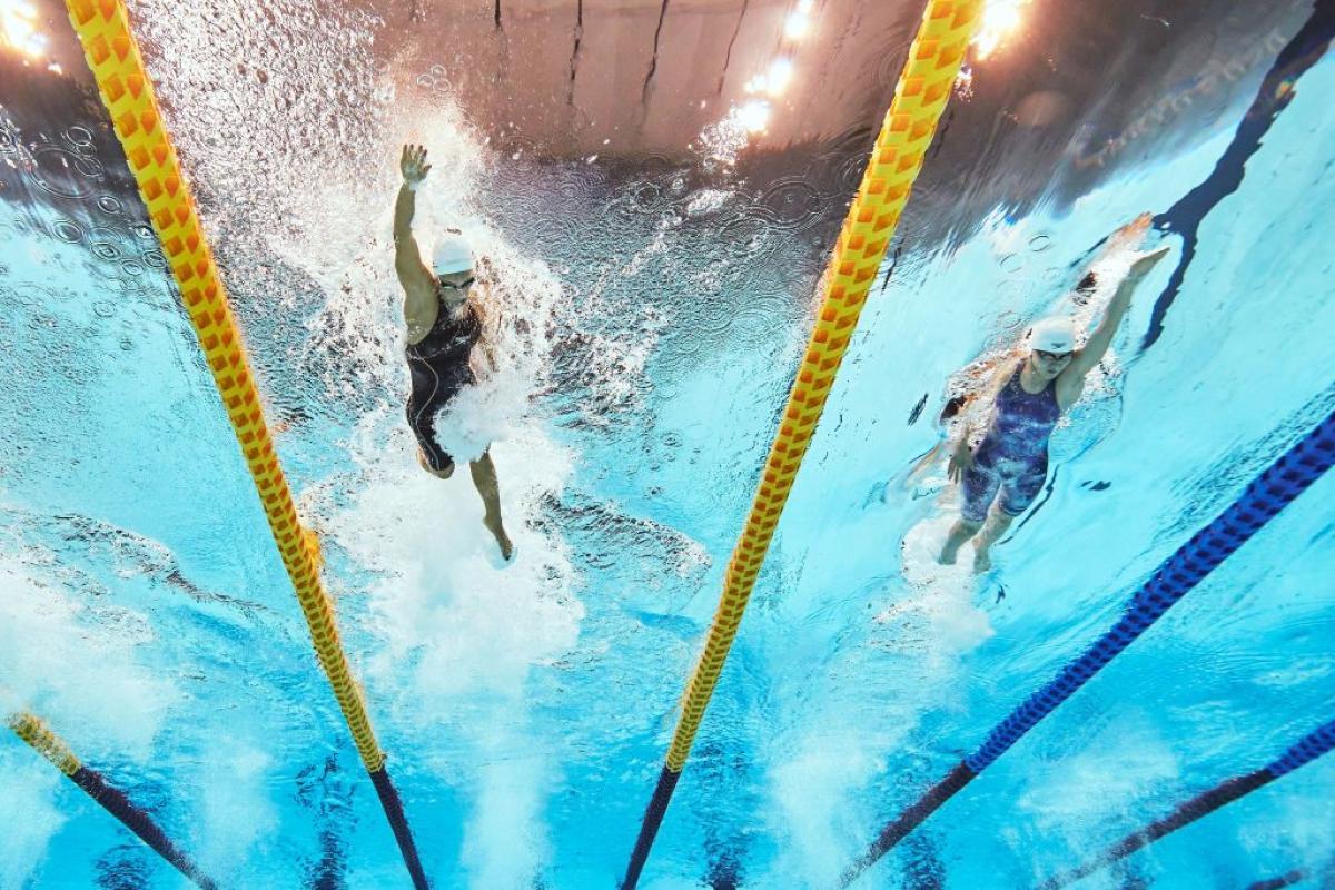 Underwater image of two female swimmers competing