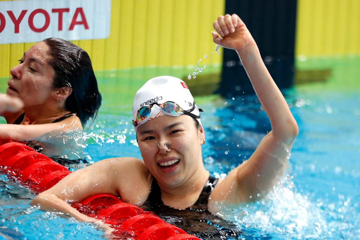An athlete celebrates her gold medal