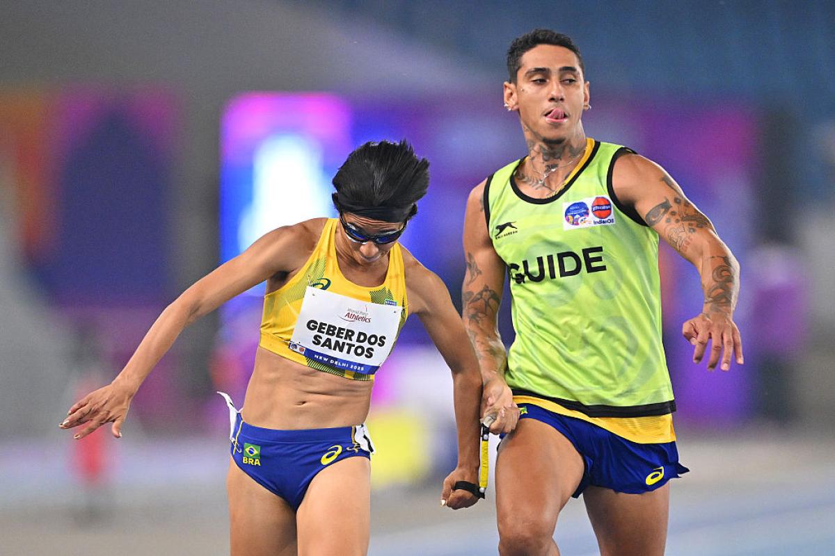 A female sprinter and her guide in a race