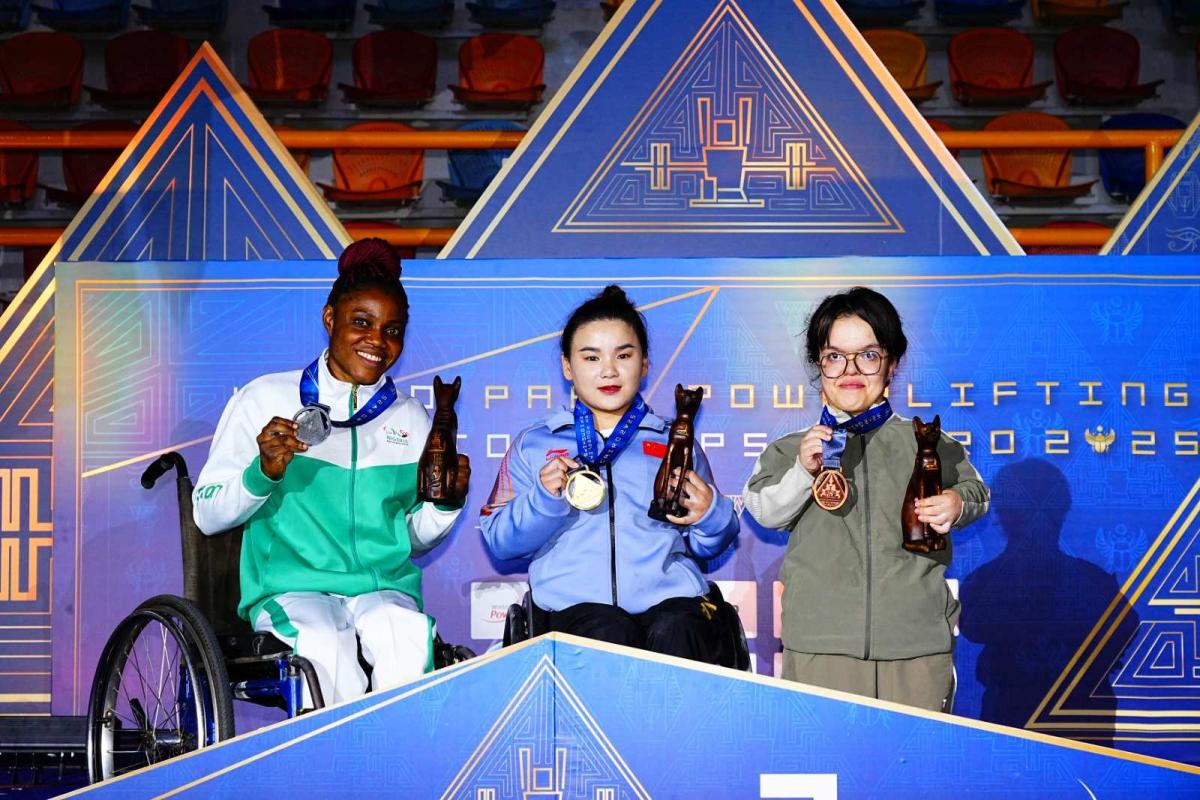 Players pose on the podium with their medals