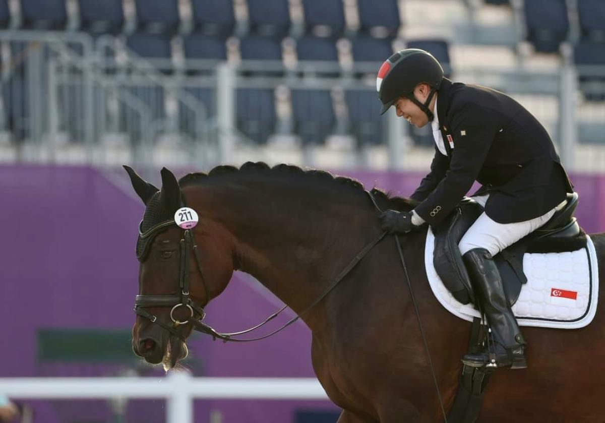 A photo taken from the side of a Para equestrian rider