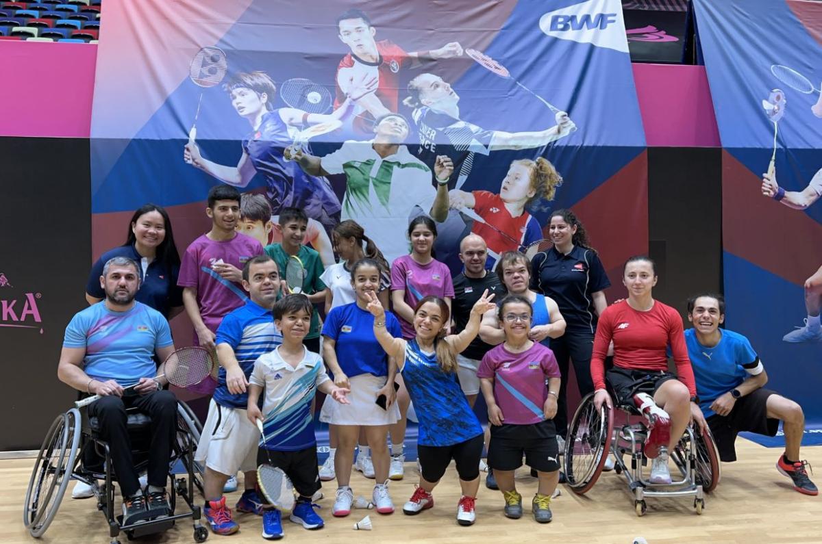 A group of Para badminton players and officials pose for a photo