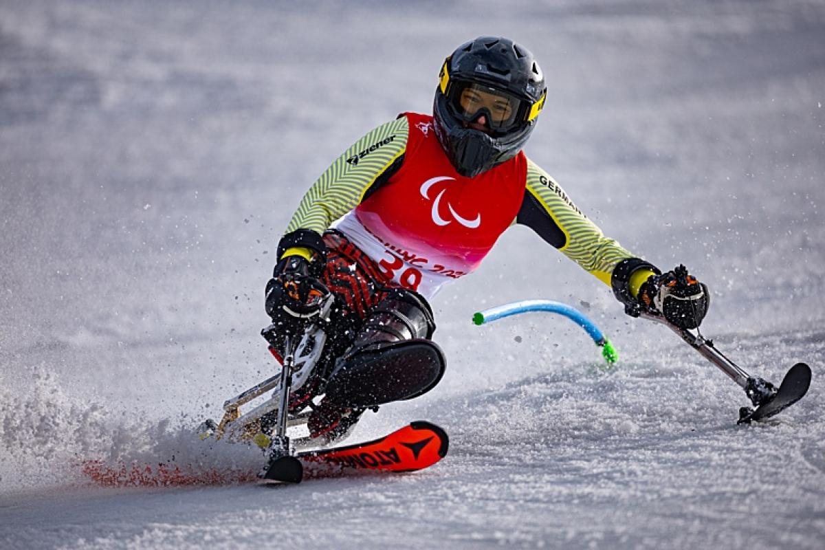A female sit-skiing athlete in action