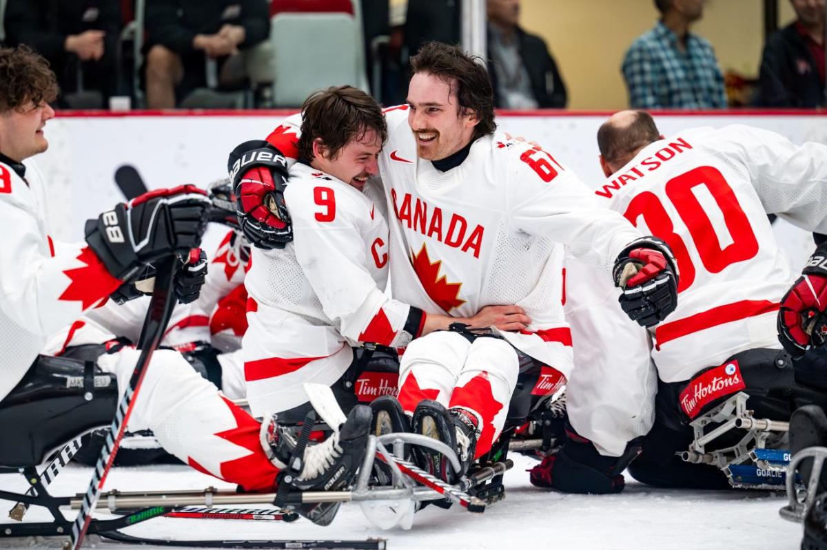 Two Para ice hockey players celebrate on ice after winning the Calgary 2024 World Para Ice Hockey Championships