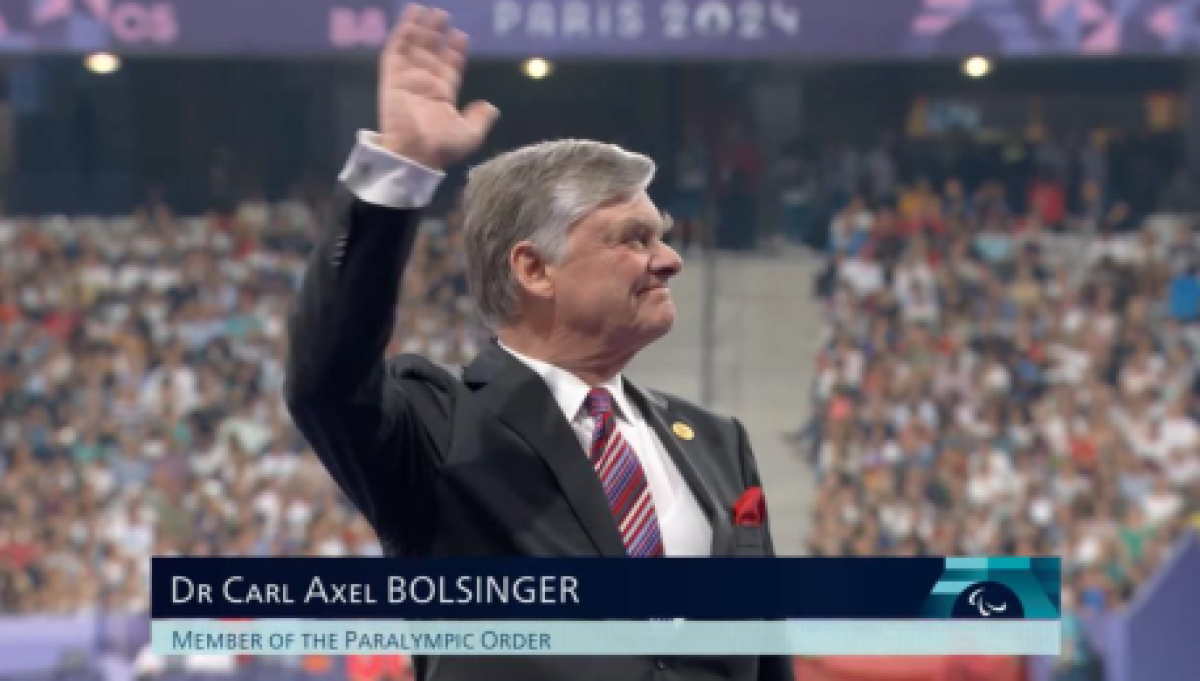 Dr Carl Axel Bolsinger is waving in a stadium 