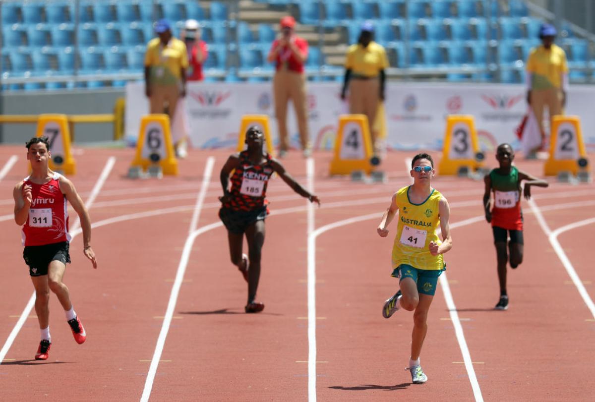 Four young Para athletes on a red track