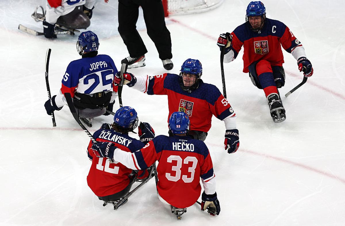 Four Czech Para ice hockey players celebrating a goal