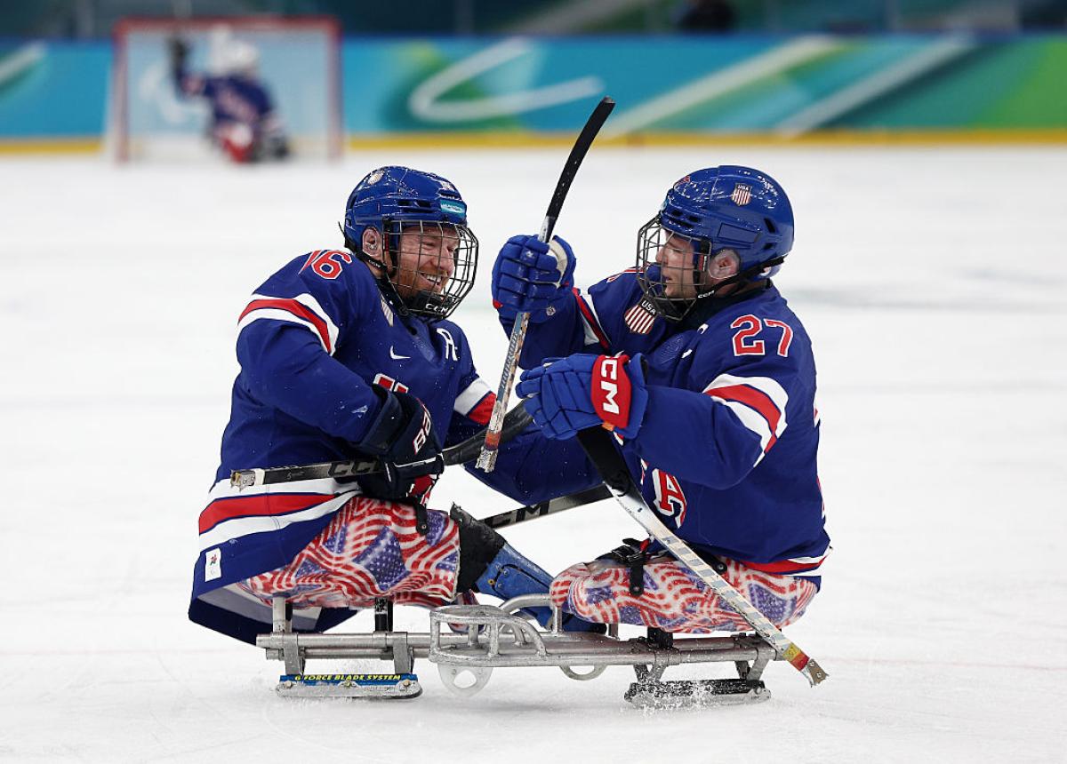 Two USA Para ice hockey players celebrating