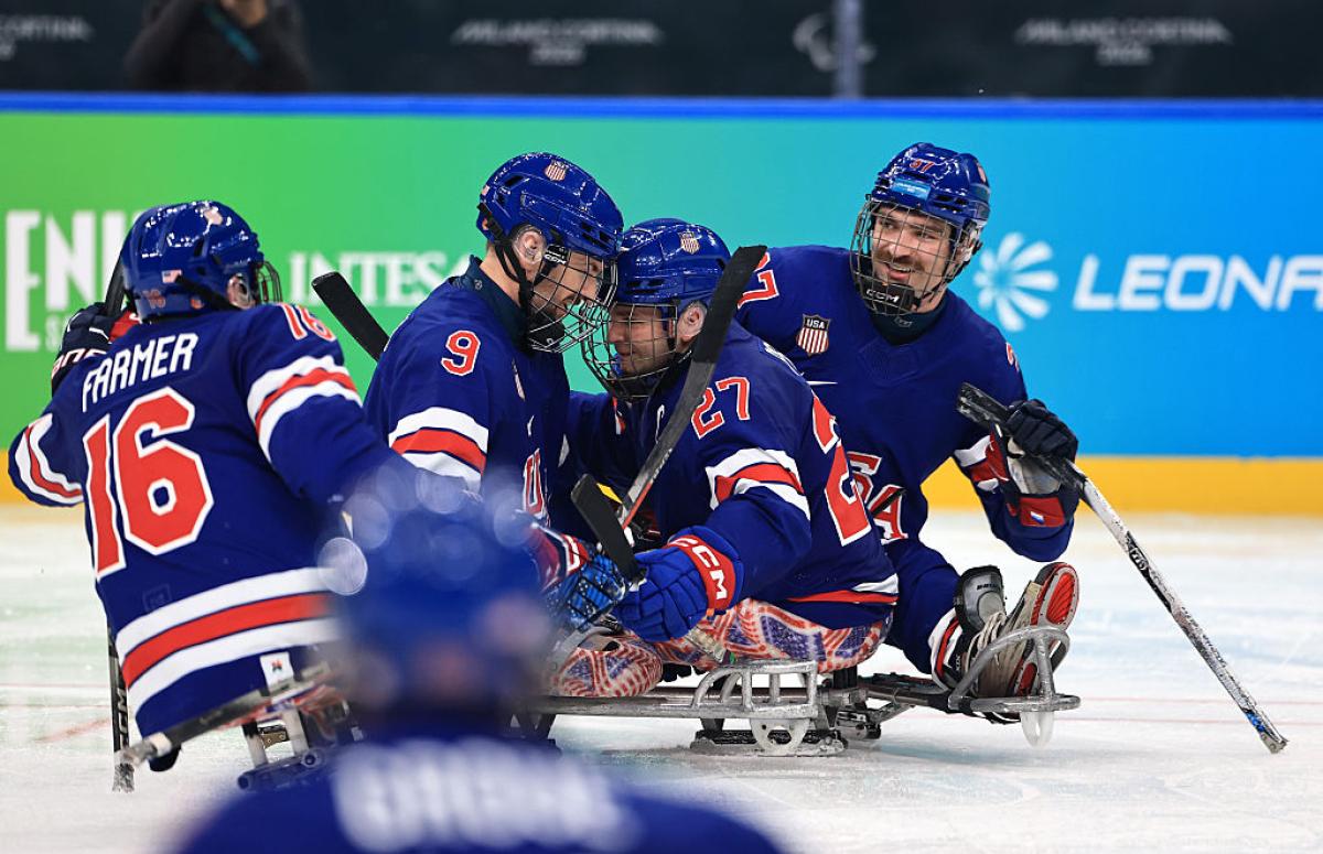 Four USA Para ice hockey players celebrating on ice