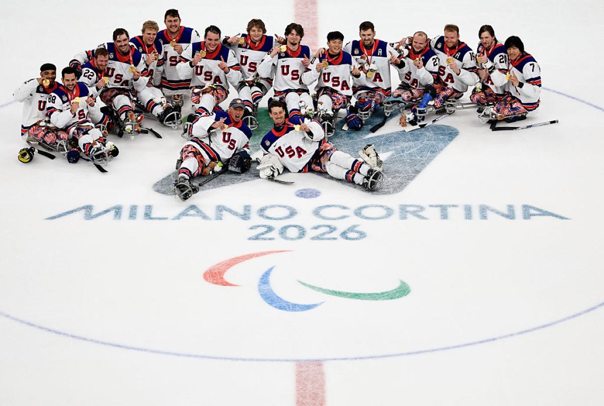 The USA Para ice hockey team celebrating with their medals on ice