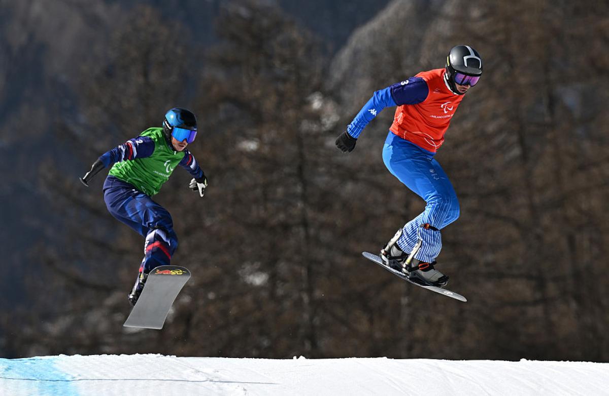 Two male Para snowboarders in competition