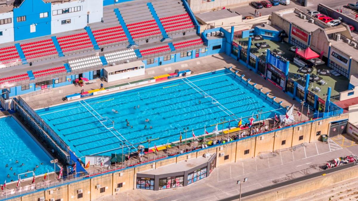 An aerial view of an outdoor competition swimming pool