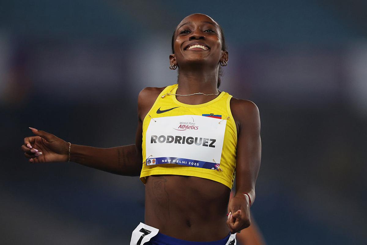 A female Para athletics runner smiling at the end of a race