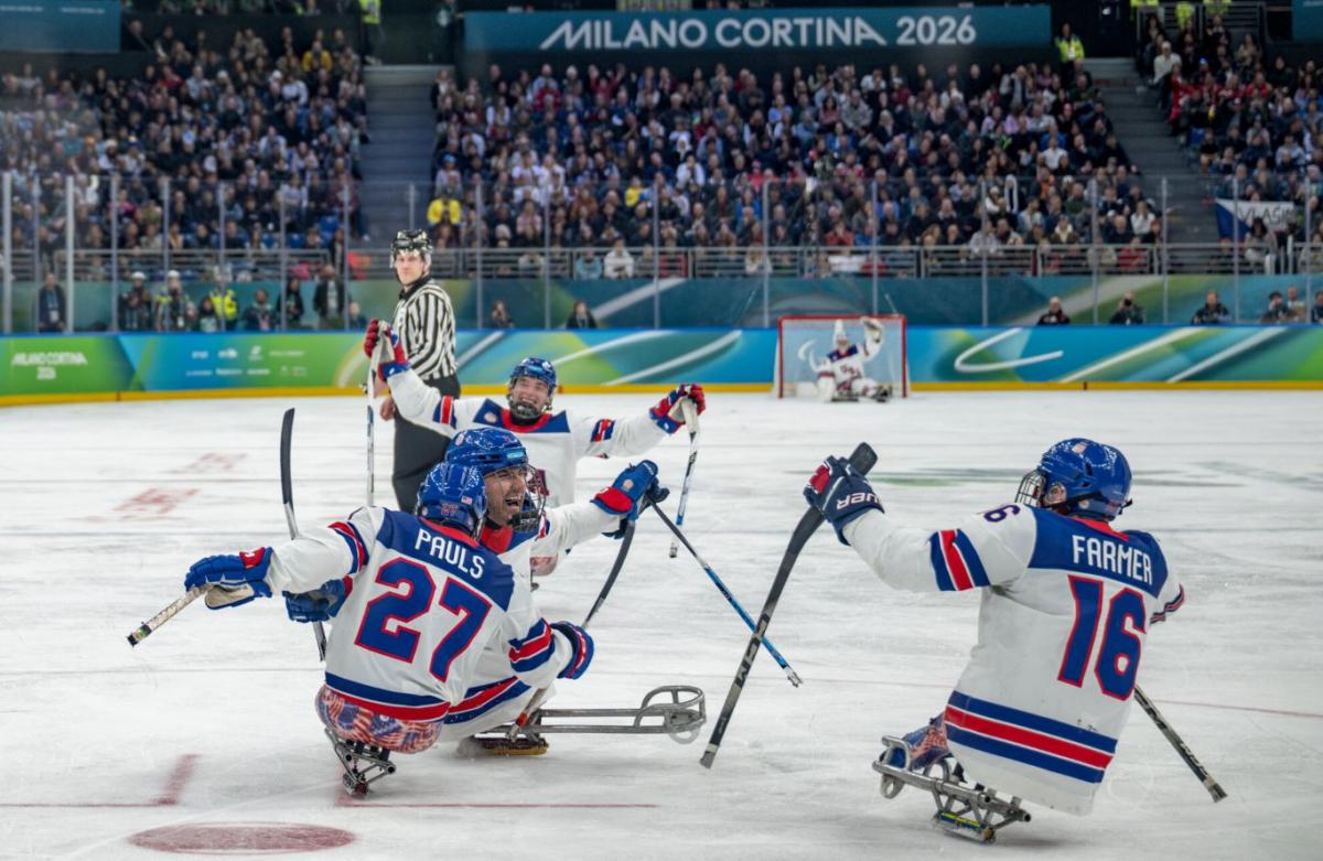 Four USA para ice hockey players celebrating on the Milano Cortina 2026 ice rink
