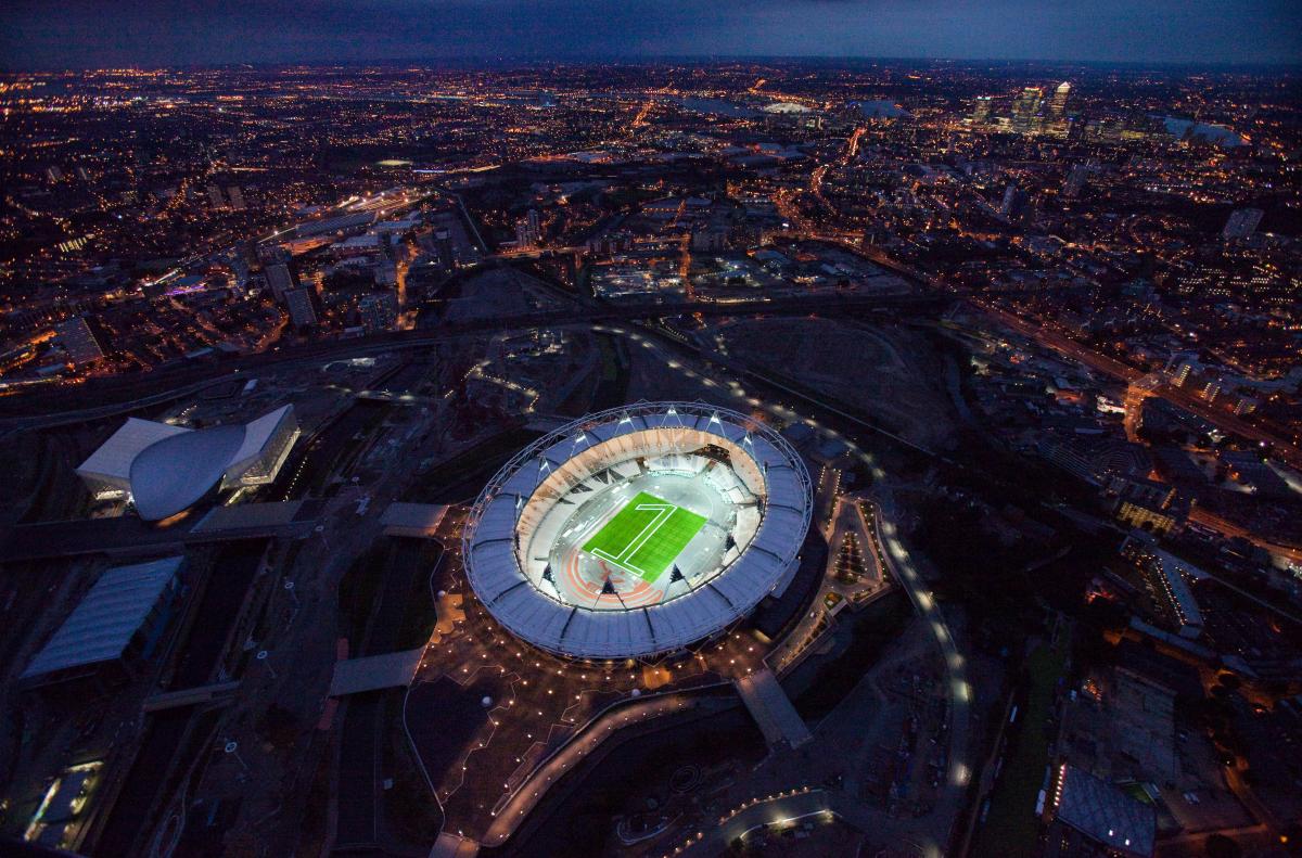 Aerial view of the London 2012 Olympic stadium with a "one" made of green lights in the center
