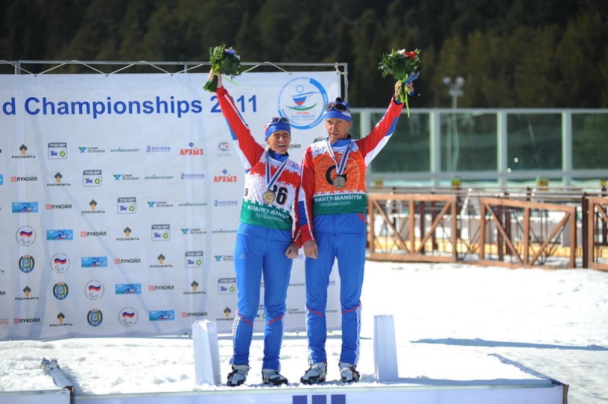 Skier on the podium with her guide