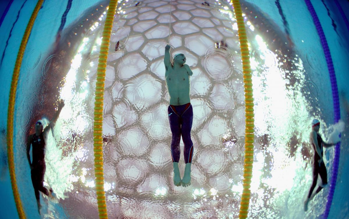Underwater shot in a swimming pool. A swimmer is photographed from below.