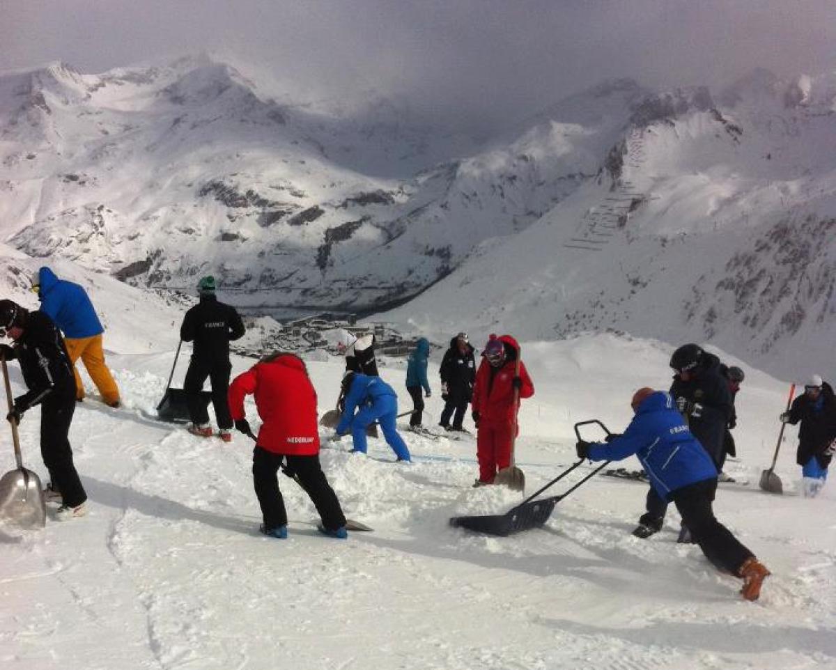 Coaches working hard on the slope to prepare for the race.