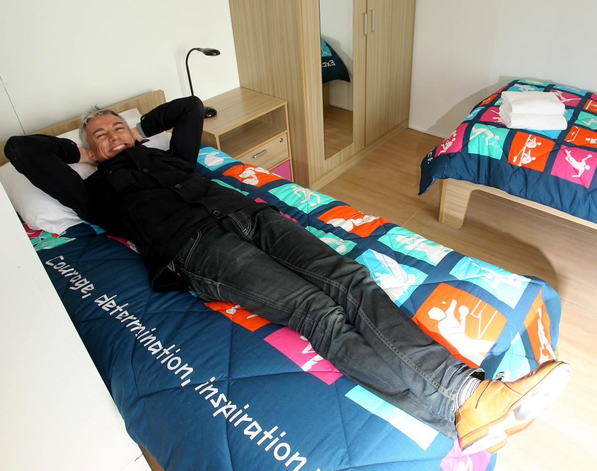 Jonathan Edwards visits the first completed Games-time apartments in the Olympic and Paralympic Villages Man on a bed