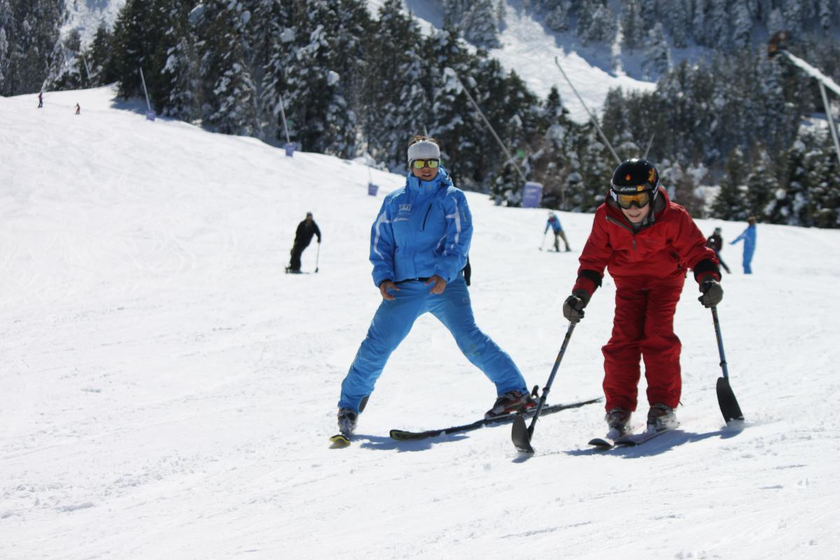 boy skiing with coach